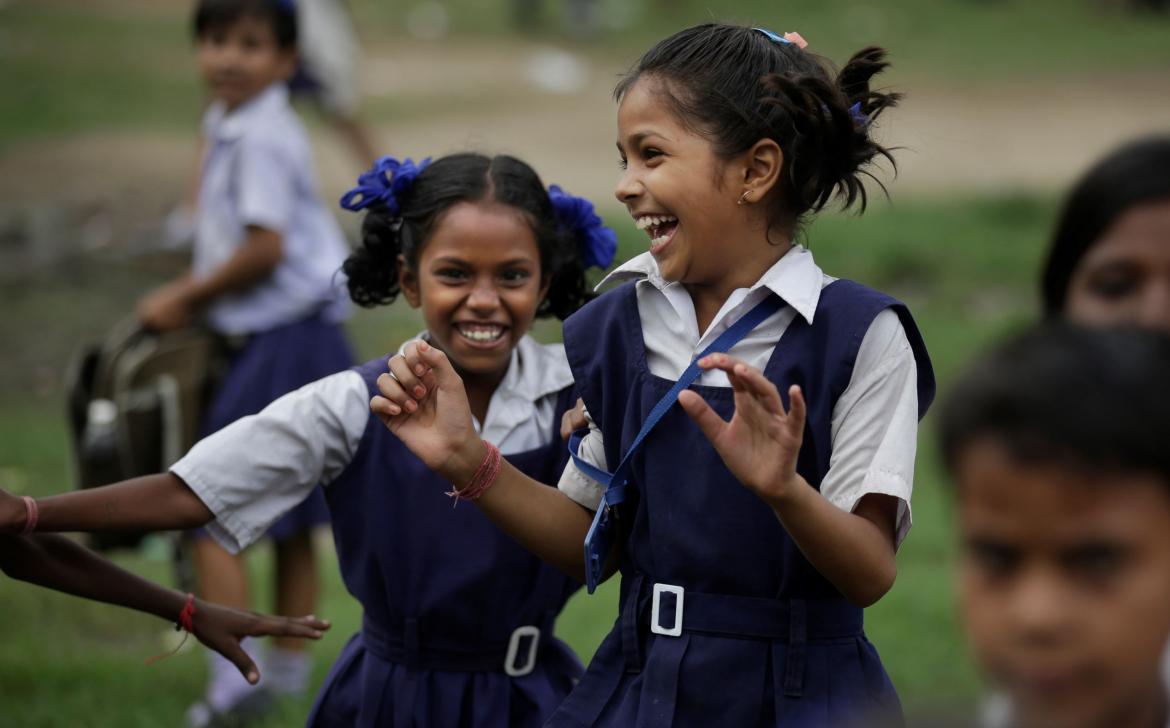 Young girls laughing together at golden hour
